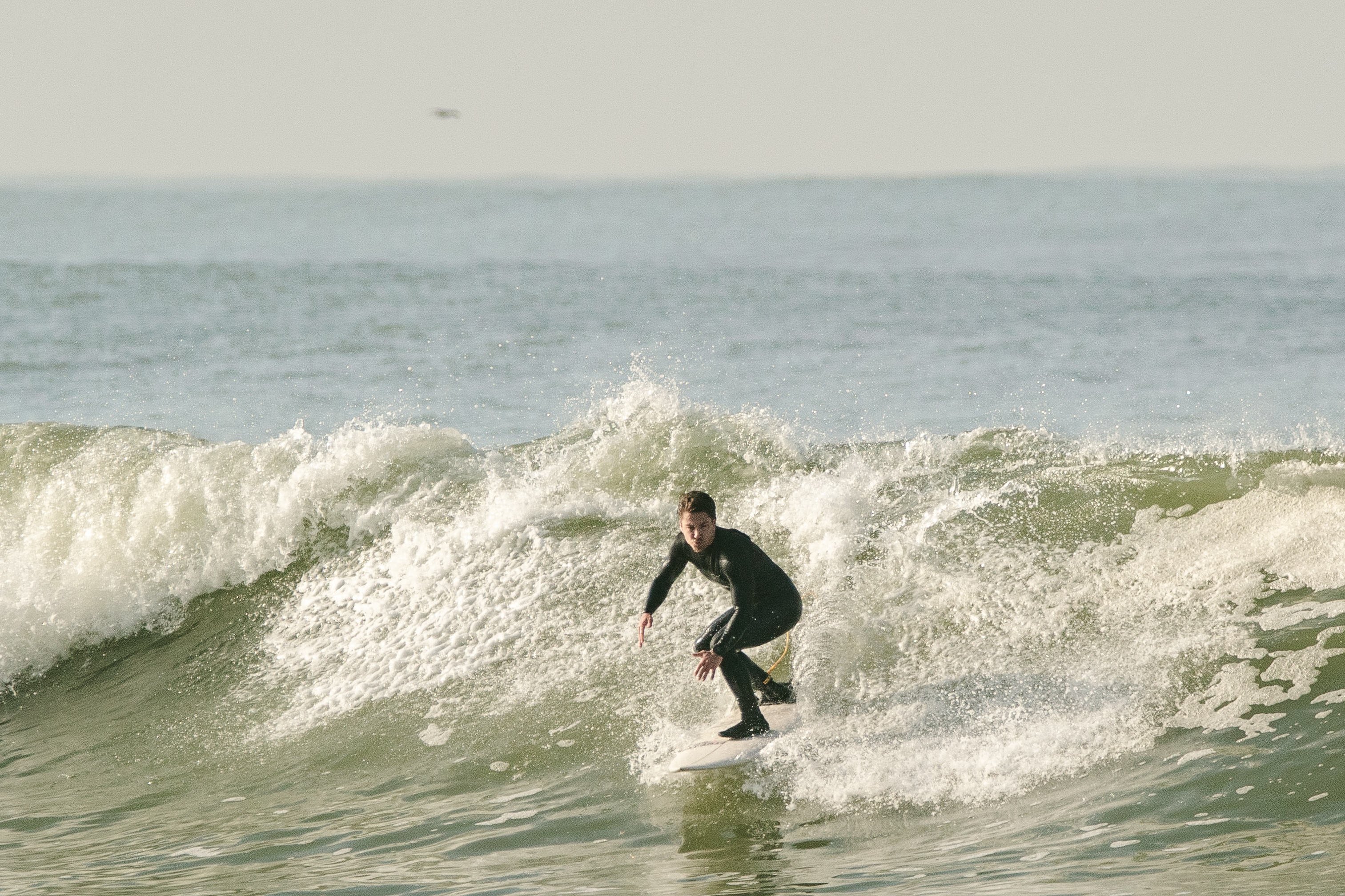 Eugene surfing a wave on the north coast of Portugal